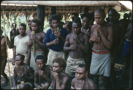 Men posing with panpipes.
