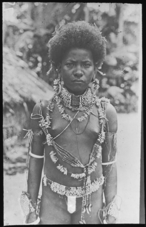 Girl of Santa Ana, wearing jewelry of porpoise and dogs teeth, shell bracelets