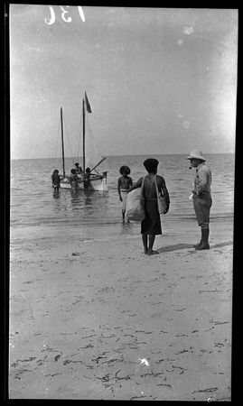 Lambert and others about to board a small boat, Papua