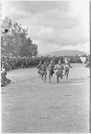 Government-sponsored festival in Tabibuga: running girls race, watched by crowd