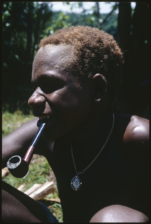 Portrait of young man with pipe.