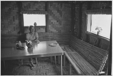 Edwin Cook&#39;s house in Kwiop: Nancy Cook at a table