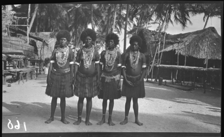 Women of coastal village near Yule Island, possibly Mekeo, wearing jewelry, including kina, a cescent shell valuable necklace
