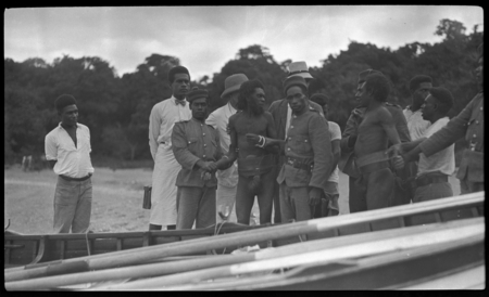 Two men being arrested, and brought on boat, at Malua Bay, Malekula; Malakai Veisamasama in back, on left