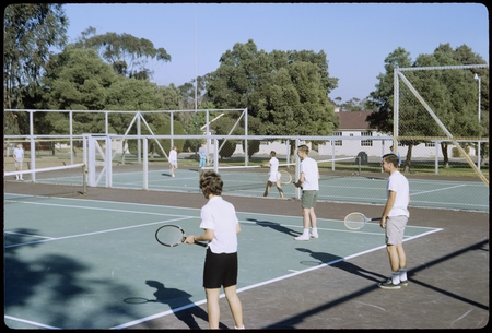 Students playing tennis on Matthews campus tennis courts