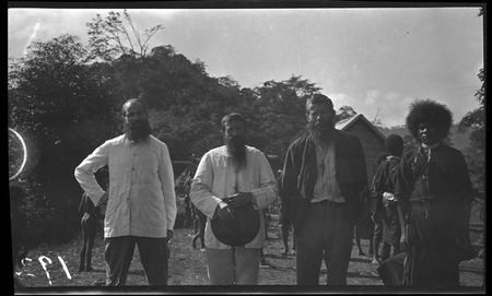 Priests, and one of Lambert&#39;s assistants at a Catholic mission in mountains of Central Province
