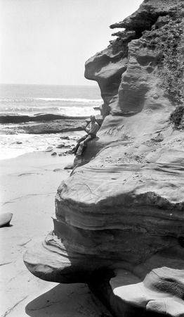 Sandstone cliffs, etched by differential erosion of waves and wind-driven sand, on the coast north of Médano Valley