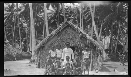 Mixed group in Potaminam Village, Ninigo Islands, in front of house