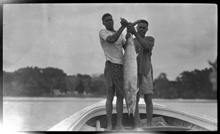 Two men holding a kingfish caught by Lambert