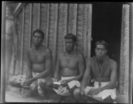 Men seated in front of a house, probably on Sikaiana