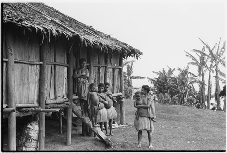 Tinami, inland Bunabun women and children next to building, probably mission clinic