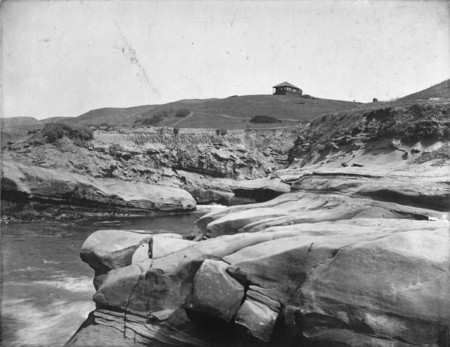 Sandstone cliffs showing erosion of upper stratum. Probably La Jolla, 1906