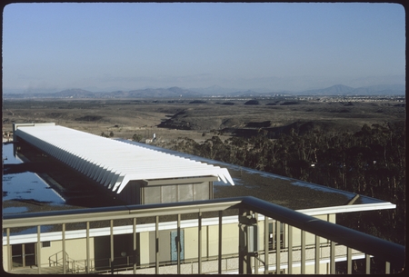 Roof of Mayer Hall with undeveloped mesas in background, facing southeast