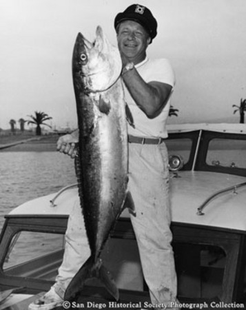Man holding catch of yellowtail tuna