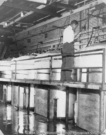 Interior view of American Agar and Chemical Company kelp processing facility showing man [inspecting extraction tanks?]
