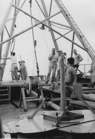 John Isaacs (center) with crew works with oceanographic instrumentation off the stern of R/V Spencer F. Baird, Bikini Atol...