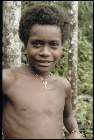 Young man with key around neck.
