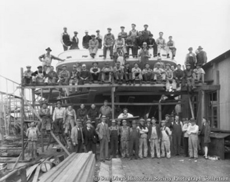 Group portrait of San Diego Marine Construction Company workers posing at stern of tuna boat Alert, under construction