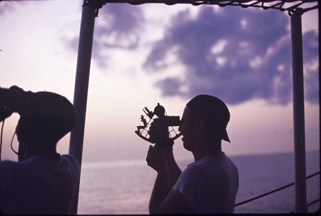 Using a sextant to determine latitude and longitude at sea, on the USC&amp;GS Pioneer during the International Indian Ocean Ex...