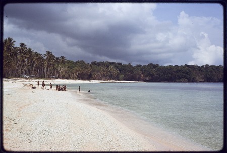 Beach at Kaibola on the north coast of Kiriwina, group of children in the distance