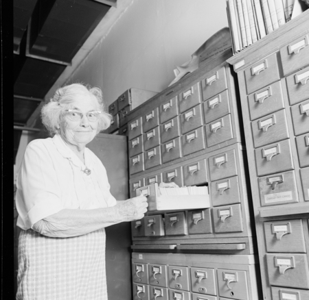 Laura Clark Hubbs with card catalog in the Hubbs Library