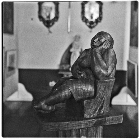 Wood sculpture of resting woman