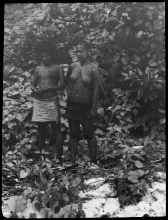 Two young women near bushes
