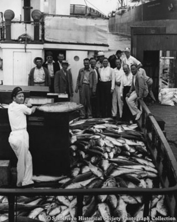 Otto C. Kiessig (left) and group of men with catch of fish on boat deck