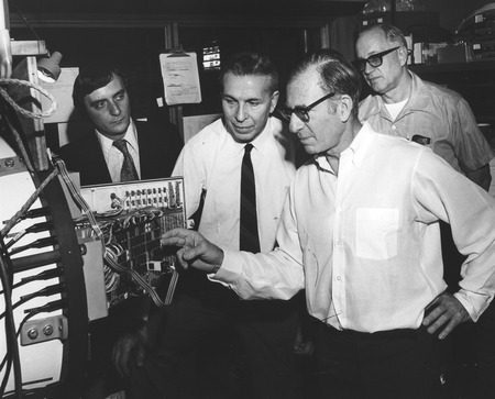 Walter Heinrich Munk (foreground) viewing deep-ocean internal waves recording system, with Michel J.M. Beguery (left), Jea...