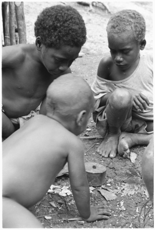 Young boys playing dice.