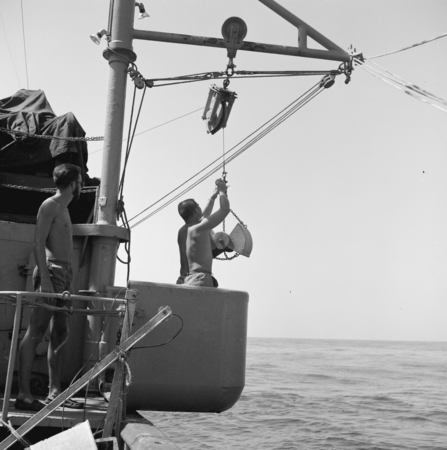 [Deploying the Peterson grab sampler from bucket on deck of R/V Spencer F. Baird]