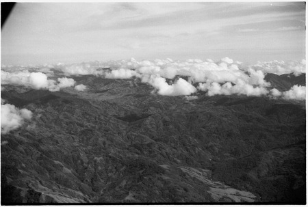 Aerial view of mountains and horizon of clouds