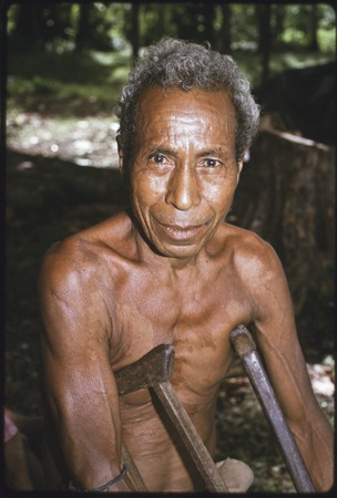 Older man with wooden crutches
