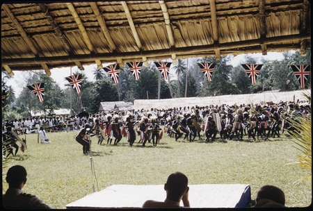 Dancers with sheilds; large official gathering