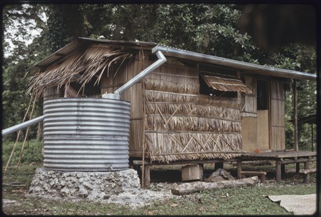 Hutchins&#39; house with cistern to catch rainwater from corrugated metal roof
