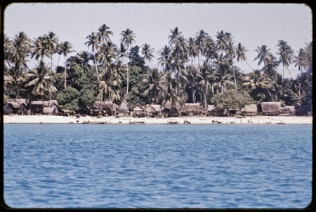Kaileuna Island: Kaduaga village houses, canoes and beach