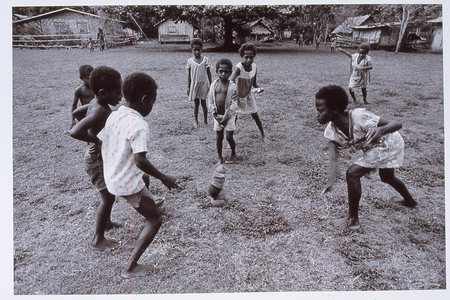 Children play kick the coconut shell