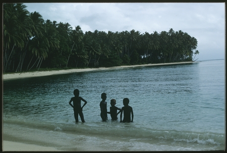 Children swimming at the coast.