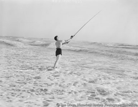 Young man surf fishing