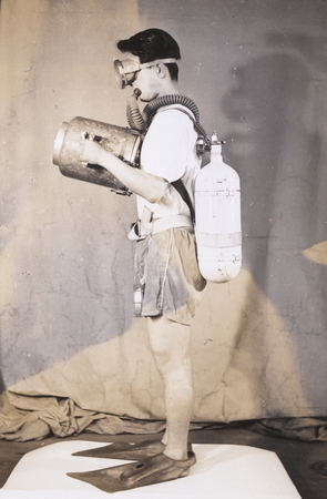 Man modeling early SCUBA gear and underwater camera, Japan