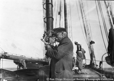 Captain of yacht Lurline looking through sextant