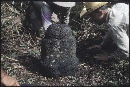Archaeologists Kenneth Emory and Pierre Verin examine Ti&#39;i (tiki) statue used as boundary marker