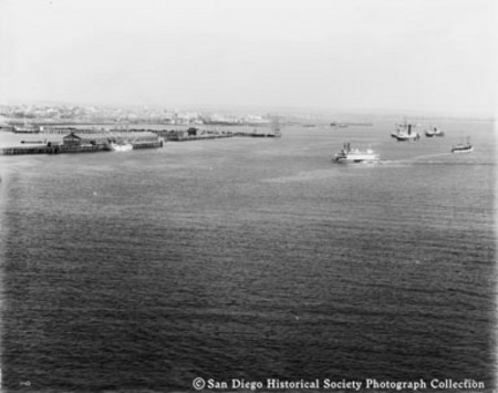 View of San Diego harbor showing Santa Fe and Pacific Coast Steamship Company wharves, from deck of armored cruiser USS Sa...