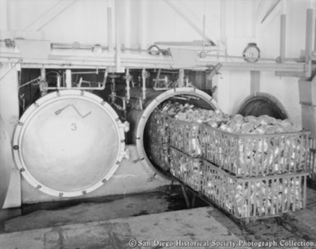 Sealed cans of tuna ready to be loaded into pressure cooker at Westgate Sea Products Company