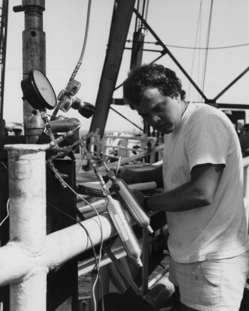 Organic geochemist Tom McDonald taking gas samples from the pressure core barrel aboard the D/V Glomar Challenger (ship) f...