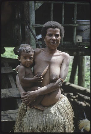 Woman holding infant, Tukwaukwa village on Kiriwina