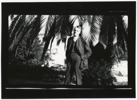 Fletcher son, standing near palm tree