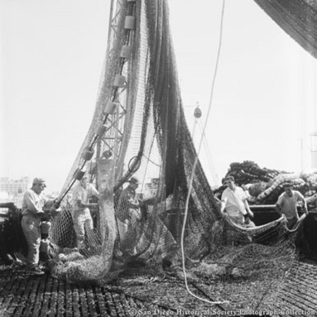 Men handling hoisted fishing net on Embarcadero