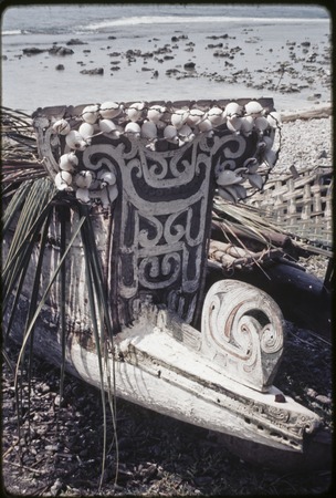 Canoes: carved and painted prowboard and splashboard of kula canoe, white cowrie shells attached to splashboard