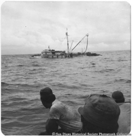 Crew on lifeboat watches sinking of tuna boat Normandie
